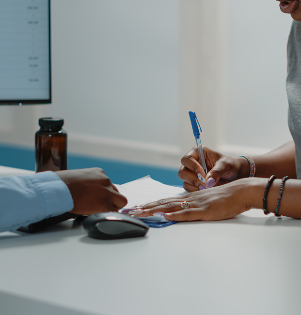 Two women discussing documents at a kitchen table